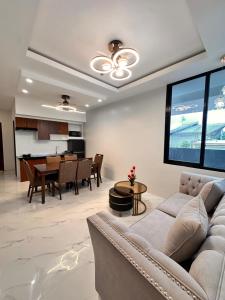 a living room with a couch and a table at KJSGrandeInn in Manolo Fortich