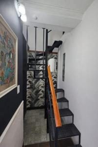 a spiral staircase in a room with a painting at Departamento cómodo y renovado a pocas cuadras del parque mitre! in Corrientes