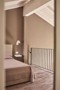 a bedroom with a bed and a desk on a wall at Vigne dei Mastri in Costigliole dʼAsti