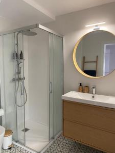 a bathroom with a shower and a sink and a mirror at Salitre - Boa Onda in Cee +5 photos