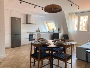 a kitchen and living room with a table and chairs at Salitre - Boa Onda in Cee