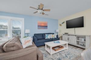 a living room with a couch and a flat screen tv at 7662 - Sea La Vie in Avon