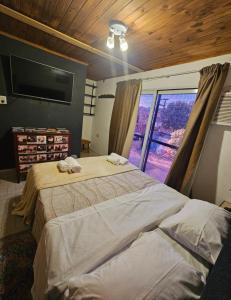 a bedroom with a large bed and a large window at Departamento cómodo y renovado a pocas cuadras del parque mitre! in Corrientes