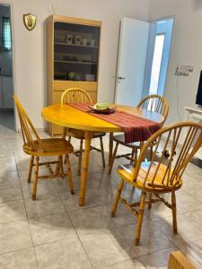a wooden table and chairs in a kitchen at Betania in Carhué +20 photos
