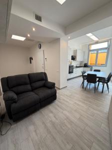 a living room with a couch and a table at Alba&Tramonto in Arbus