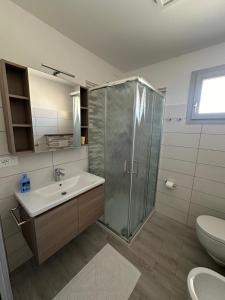 a bathroom with a shower and a sink and a toilet at Alba&Tramonto in Arbus +43 photos