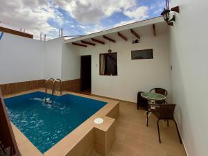 a swimming pool in the middle of a house at Huacachina Desert II in Ica