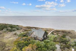 an aerial view of a house on a hill next to the ocean at 7828 - Swing Belly's Roost in Frisco
