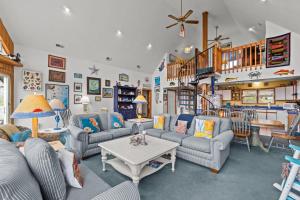 a living room with couches and a table at 7828 - Swing Belly's Roost in Frisco
