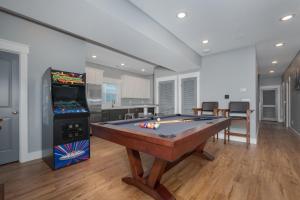 a room with a pool table and a video game at 5705 - Edgewater View in Nags Head