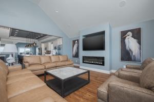 a living room with two couches and a tv at 5705 - Edgewater View in Nags Head +57 photos