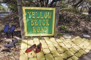 a sign for a yellow brick road with shoes in front at 4603 - Yellow Brick Road in Southern Shores