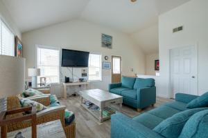 a living room with blue furniture and a flat screen tv at 7676 - Nautical by Nature in Avon