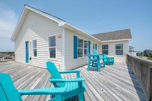 a deck with blue chairs and a house at 7676 - Nautical by Nature in Avon +40 photos