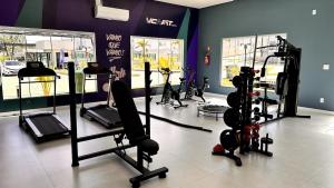 a gym with several tread machines in a room at Dona Olivia Universidade 16 in Vitória da Conquista