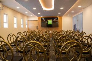 a row of chairs in a room with a podium at Ibis Styles Mexico Reforma in Mexico City