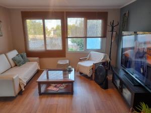a living room with a couch and a tv at Casa Nido in Mercedes