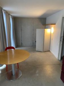 a small room with a table and a refrigerator at LA CODORNIZ in Villaviciosa