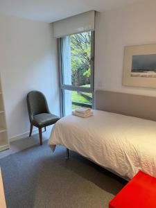 a bedroom with a bed and a chair and a window at LA CODORNIZ in Villaviciosa +27 photos