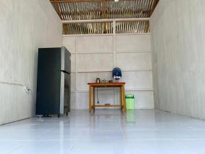 a room with a table and a black refrigerator at The Green Pearl Paradise in Biluhu +22 photos