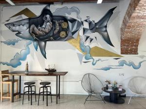 a dining room with a shark mural on the wall at Hotel Cataviento in Veracruz