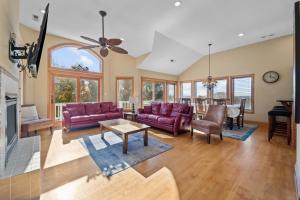 a living room with red couches and a table at 3947 - Leg-O Duck in Duck