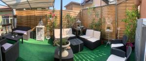 a patio with chairs and plants and a fence at Monolocale Pink Borgo Roma GB Rossi friendly Verona in Verona