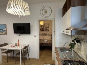 a kitchen and dining room with a table and a television at Dolce Vita in Bari