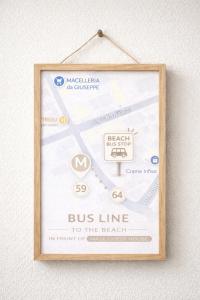 a bus line sign hanging on a wall at Maze Guest House in Alghero
