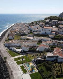 an aerial view of a town next to the ocean at Casa Praia do Fogo in Ribeira Quente