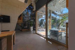 a living room with glass doors and a table and chairs at Villa Nola - Diseño Vasco, Lujo y Privacidad in San Sebastián