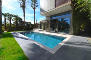 a swimming pool in the backyard of a house at Villa Nola - Diseño Vasco, Lujo y Privacidad in San Sebastián