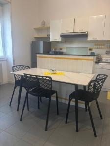 a kitchen with a table and four chairs in a room at Tower casa vacanze 1 in Anzio +16 photos