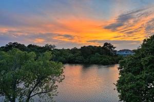 a view of a river with a sunset in the background at 1064 - Sunset Cottage in Corolla