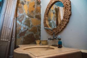 a bathroom with a sink and a mirror on the wall at Dar Duna in Adrouine +71 photos