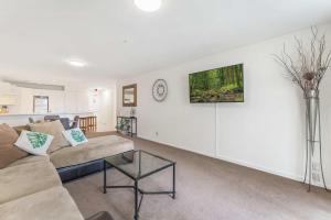 a living room with a couch and a table at Ocean Seascape - Mt Maunganui in Mount Maunganui