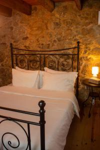a bedroom with a bed with white pillows at Refugio dos Cartolas - Mountain Retreat in São Mamede