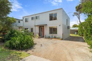 a white house with a driveway in front of it at Woolamai Sands in Cape Woolamai