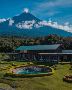 a building with a pool in front of a mountain at Finca San Cayetano in San Juan Alotenango