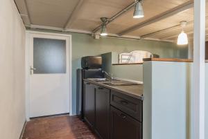 a kitchen with a refrigerator and a counter top at Loft with a ducal view in Urbino