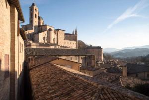 a view of a city with buildings and roofs at Loft with a ducal view in Urbino