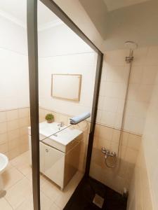 a bathroom with a sink and a shower at Village Sea House - Porto Moniz in Porto Moniz +21 photos