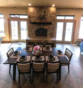 a dining room with a table with chairs and a fireplace at Alpine Luxury Chelan Vacation Rentals in Chelan