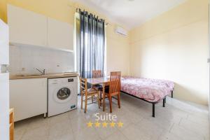 a small kitchen with a table and a bed and a sink at Casa dell'amicizia in Milan
