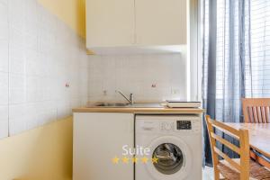 a kitchen with a washing machine and a sink at Casa dell'amicizia in Milan +6 photos
