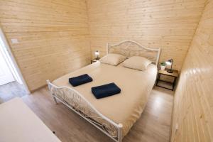 a bedroom with a white bed with two pillows on it at Le chalet au bord de seine in Les Mousseaux +89 photos