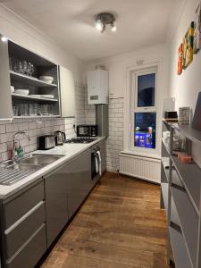 a kitchen with stainless steel appliances and a window at Spacious Bournemouth Apartment in Bournemouth +3 photos