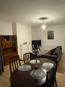 a living room with a table and a couch at Spacious Bournemouth Apartment in Bournemouth