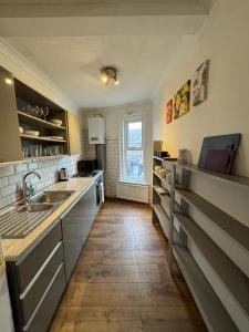 a kitchen with a sink and a counter top at Spacious Bournemouth Apartment in Bournemouth