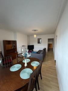 a living room with a table and a couch at Spacious Bournemouth Apartment in Bournemouth